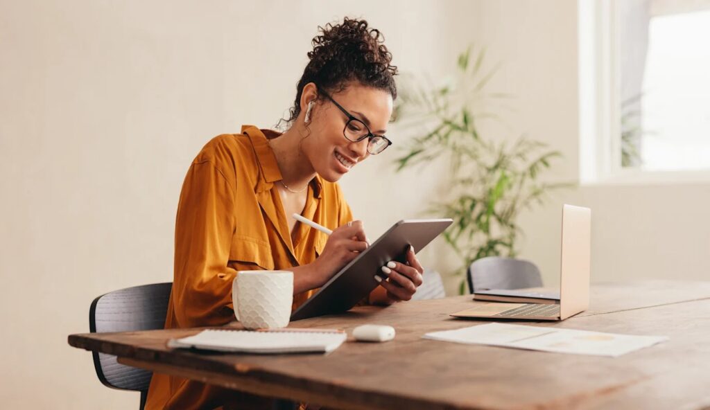 Business owner writing on iPad